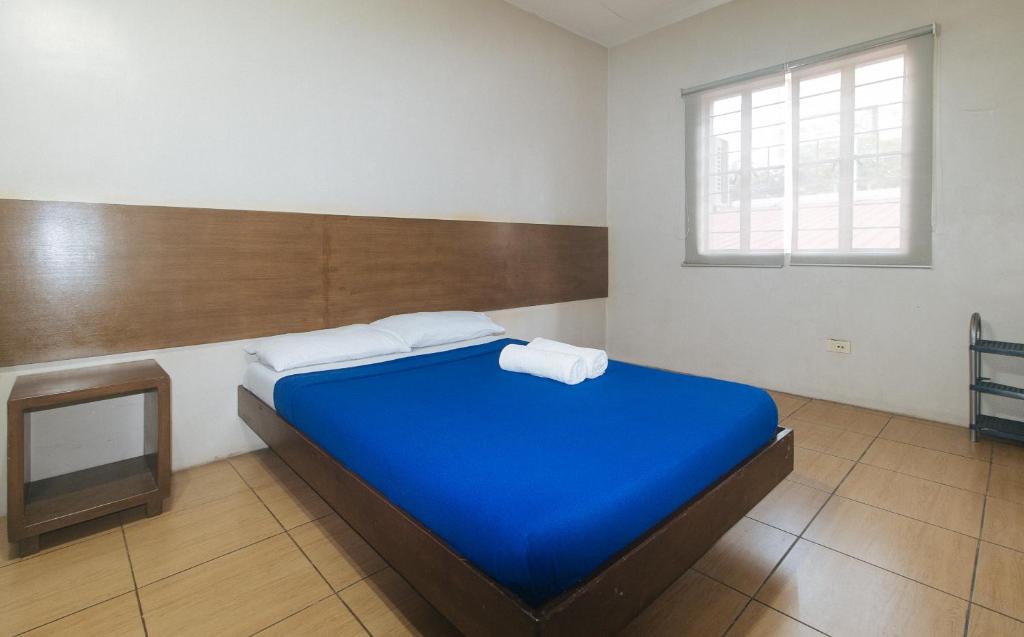 Ένα ή περισσότερα κρεβάτια σε δωμάτιο στο Metro Deluxe Residences near OWWA Pasay