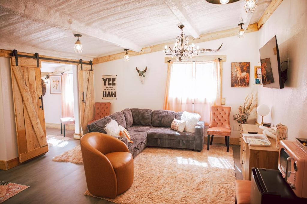 a living room with a couch and a chair at The Pink Hayloft in Nephi