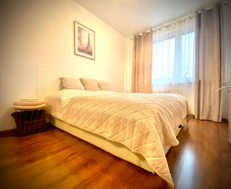 a bedroom with a large bed and a window at 3 izbový byt KNM in Kysucké Nové Mesto