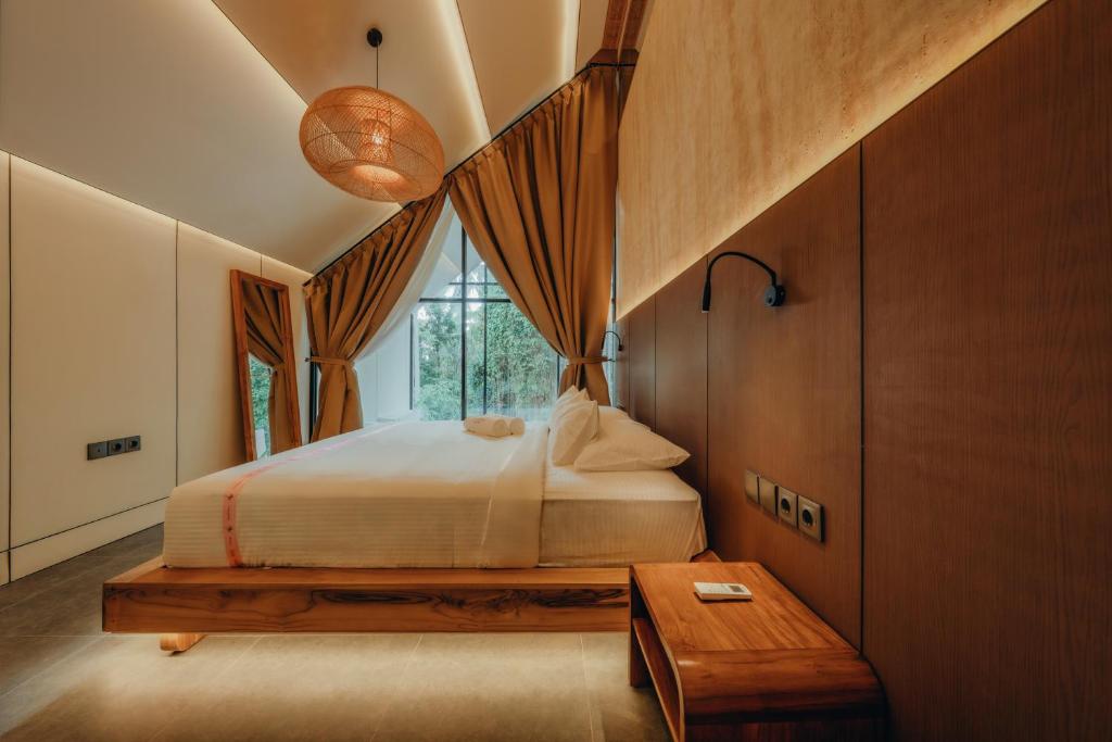 una camera da letto con un letto grande e una finestra di Moon Rock Villas by Ribas a Darmasaba