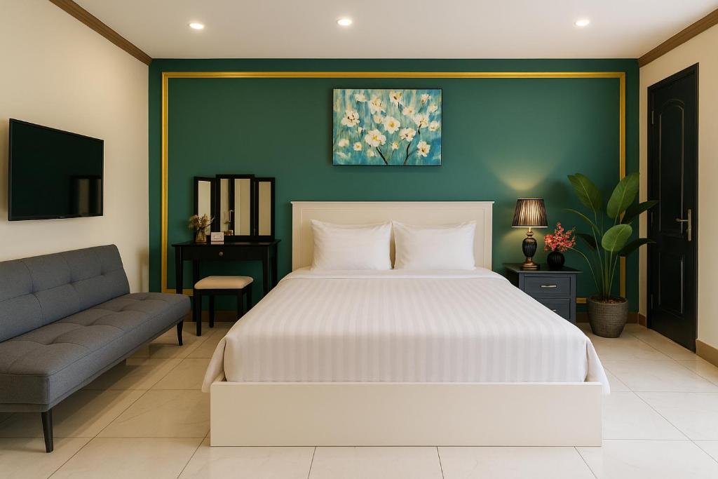 a bedroom with a white bed and a couch at La Casona Retreat in Ho Chi Minh City