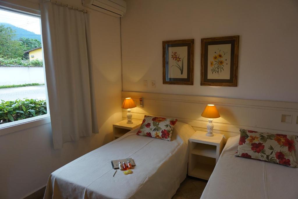 Cama ou camas em um quarto em Pousada Terra Juquehy