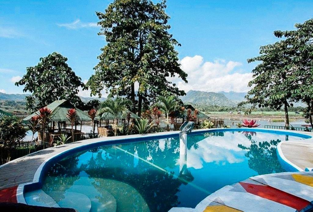 a swimming pool with a water fountain in a resort at Sunrise Garden Lake Resort in Lahit