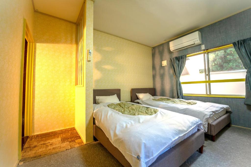 Ένα ή περισσότερα κρεβάτια σε δωμάτιο στο ロッジＴＯＮＢＯ・石打