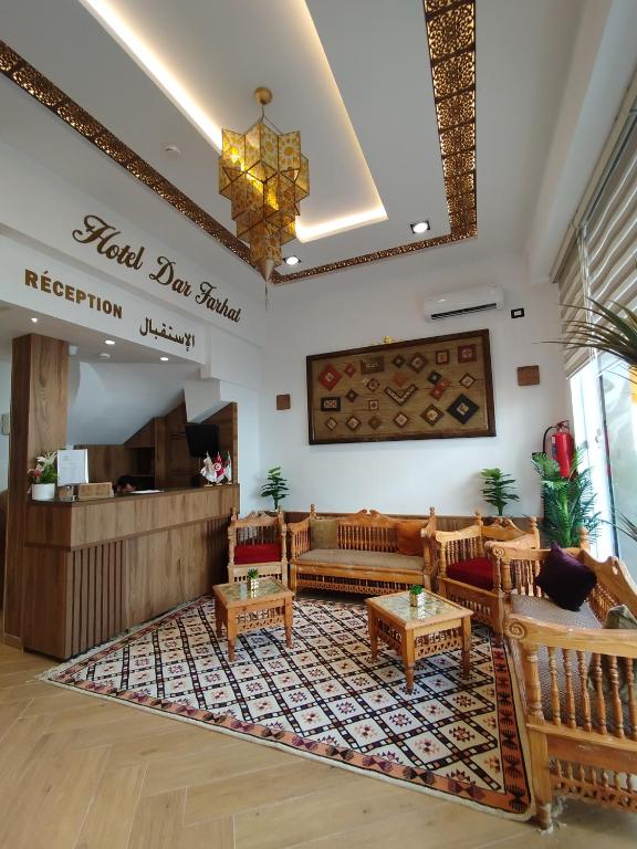 a lobby of a hotel with a waiting room with couches at Hôtel Dar Farhat in Tunis