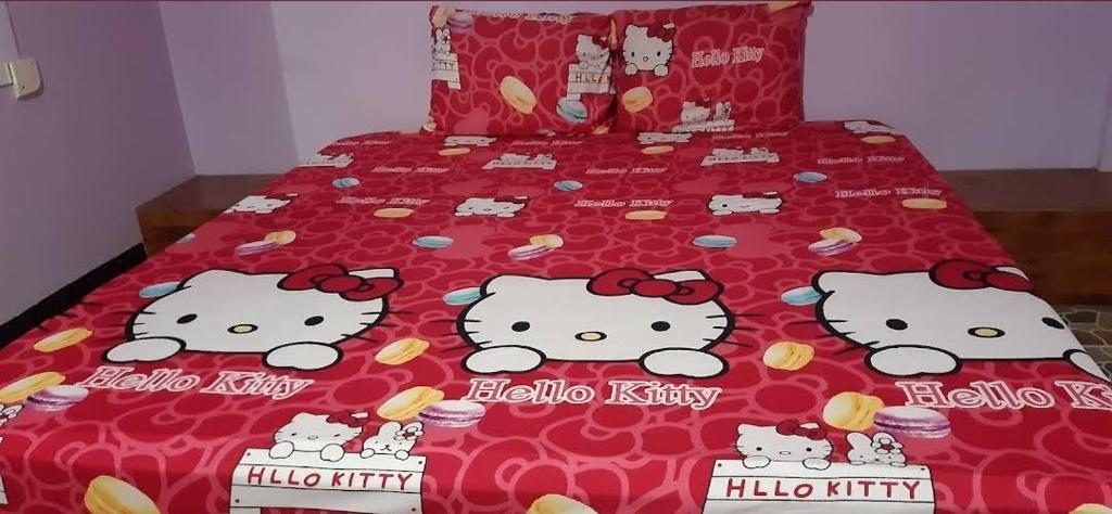 a bed with hello kitty appliques on it at Saran Resort room 11 in Buriram