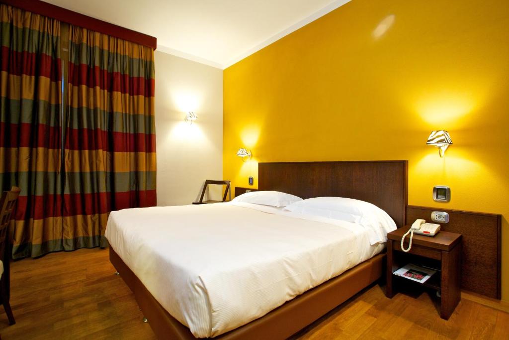 Postel nebo postele na pokoji v ubytování Hotel Dei Vicari