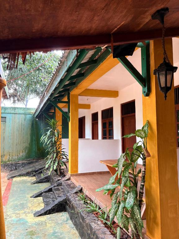 an outside view of a house with yellow at Weligama Imal Guest House in Weligama