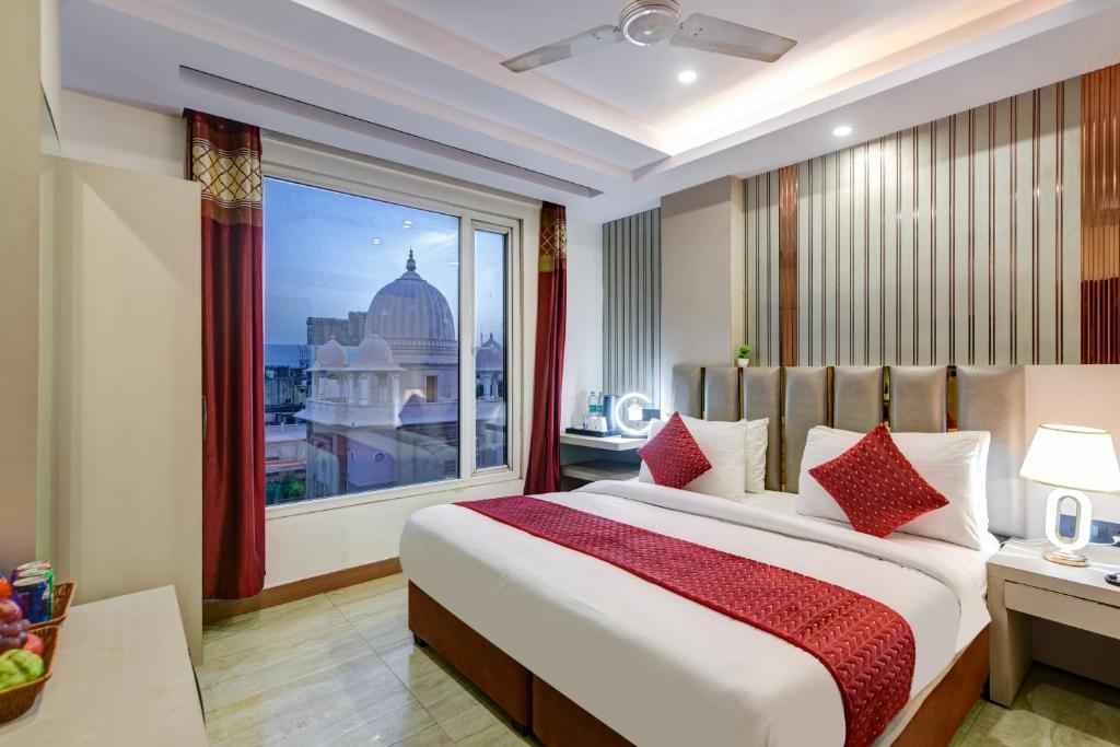 a bedroom with a large bed and a large window at Hotel Ambience Just Near New Delhi Railway Station And Connaught Place in New Delhi