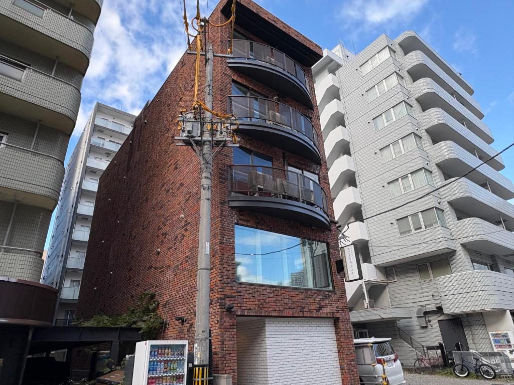 a red brick building with a building at Aparthotel STATUS SUSUKINO 102 in Sapporo