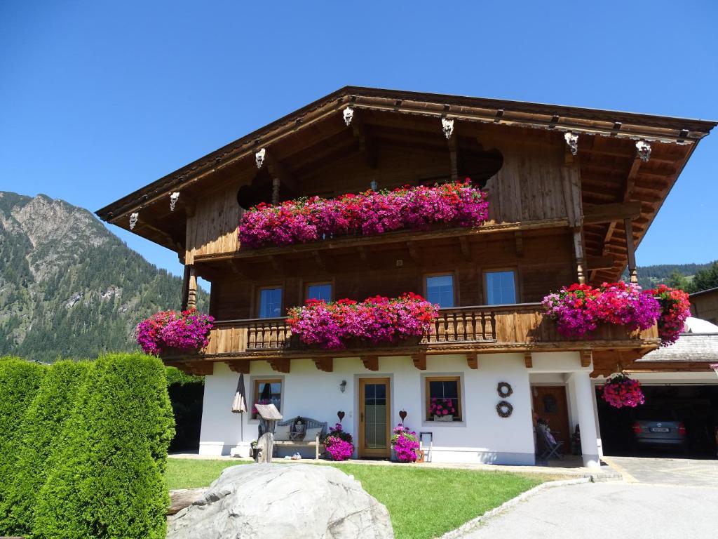 a house with flowers on the side of it at Anna's Appartement in Alpbach