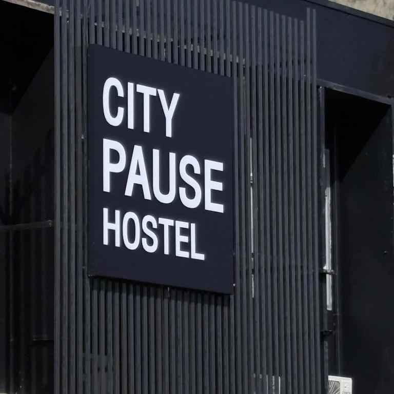 a city pause hospital sign on the side of a building at City Pause Hostel in Sathani Bang Su