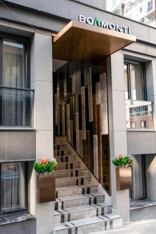 a entrance to a building with stairs in front at Boamonti Residence Sisli Apart in Istanbul