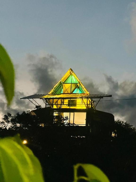 a house with a yellow roof on top at Breeze Heven Cabana in Matale