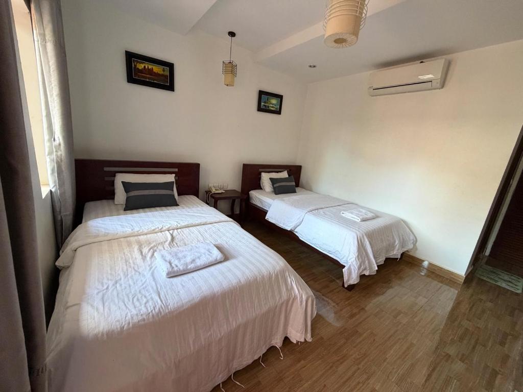 Ένα ή περισσότερα κρεβάτια σε δωμάτιο στο Monterey Angkor Boutique