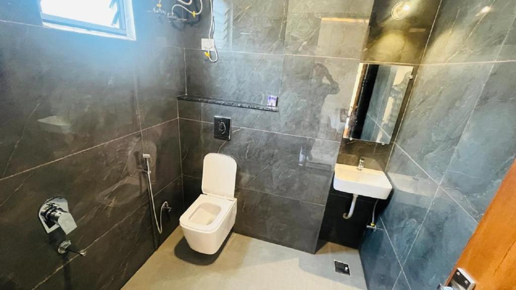 a bathroom with a toilet and a sink at legacy of chittorgarh in Chittaurgarh