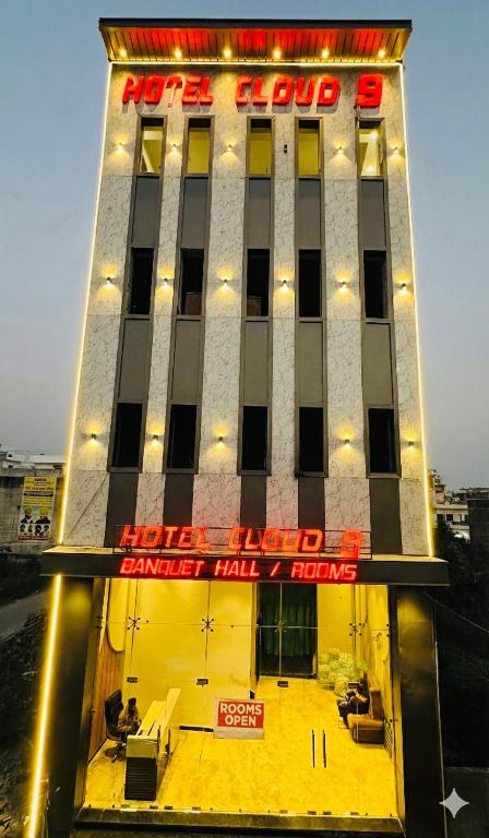 a hotel with a red sign on the front of it at Hotel Cloud 9 in Amritsar