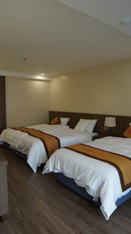 Postel nebo postele na pokoji v ubytování Marina Hotel Lạng Sơn