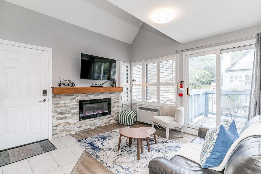 a living room with a couch and a fireplace at Mountain View Ski-In-Out Pool Shuttle to Blue in Blue Mountains