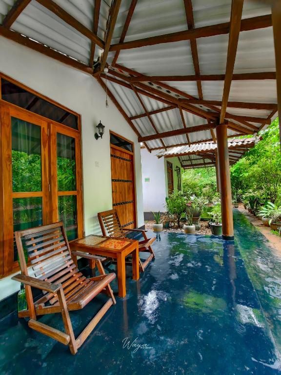 two chairs and a table on a patio at Bright Sun Safari in Udawalawe