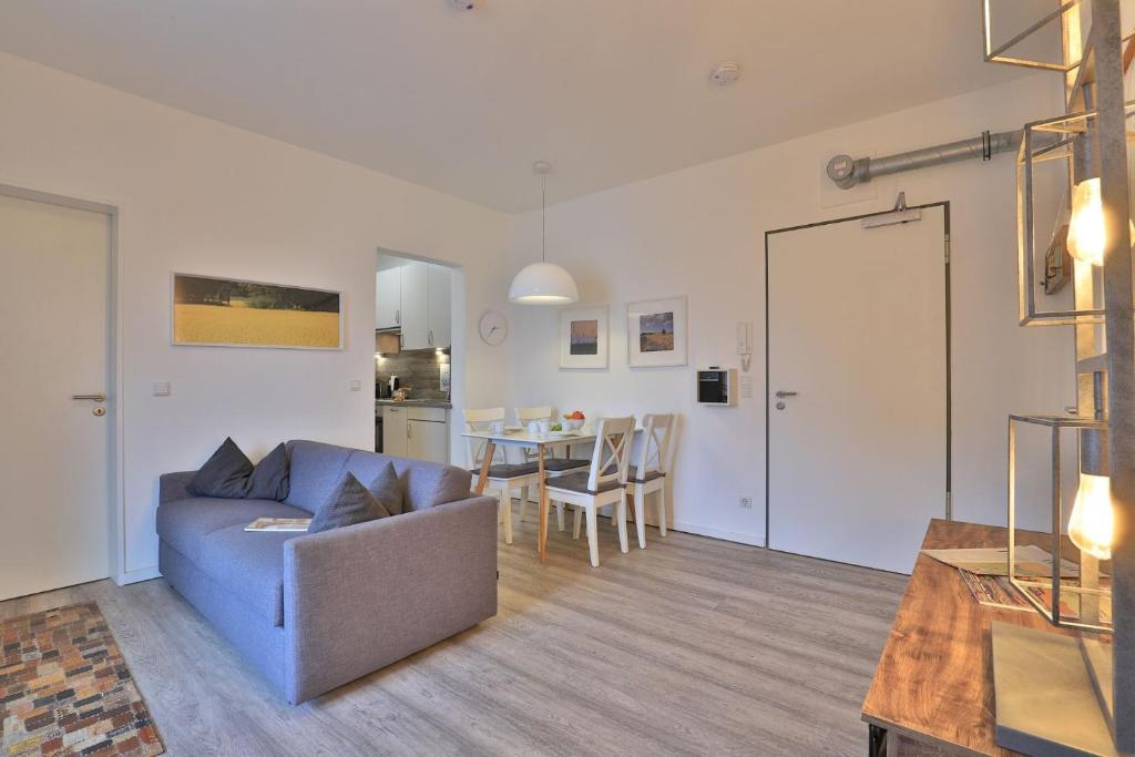 un soggiorno con un divano e un tavolo di Ohlerich Speicher App_ 12 a Wismar