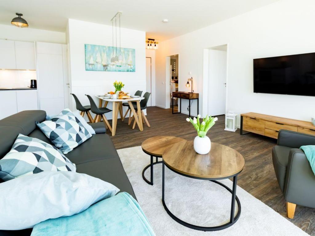 una sala de estar con un sofá y una mesa en Hafenspitze App 23, en Wismar