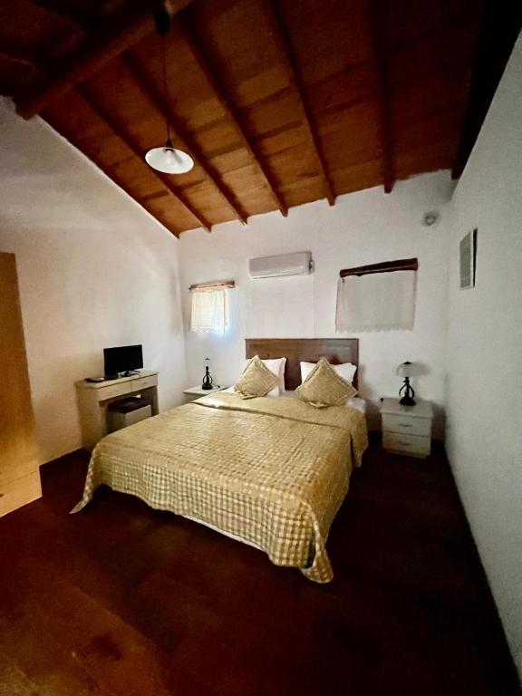 a bedroom with a large bed and a desk at Zeytin in Datca