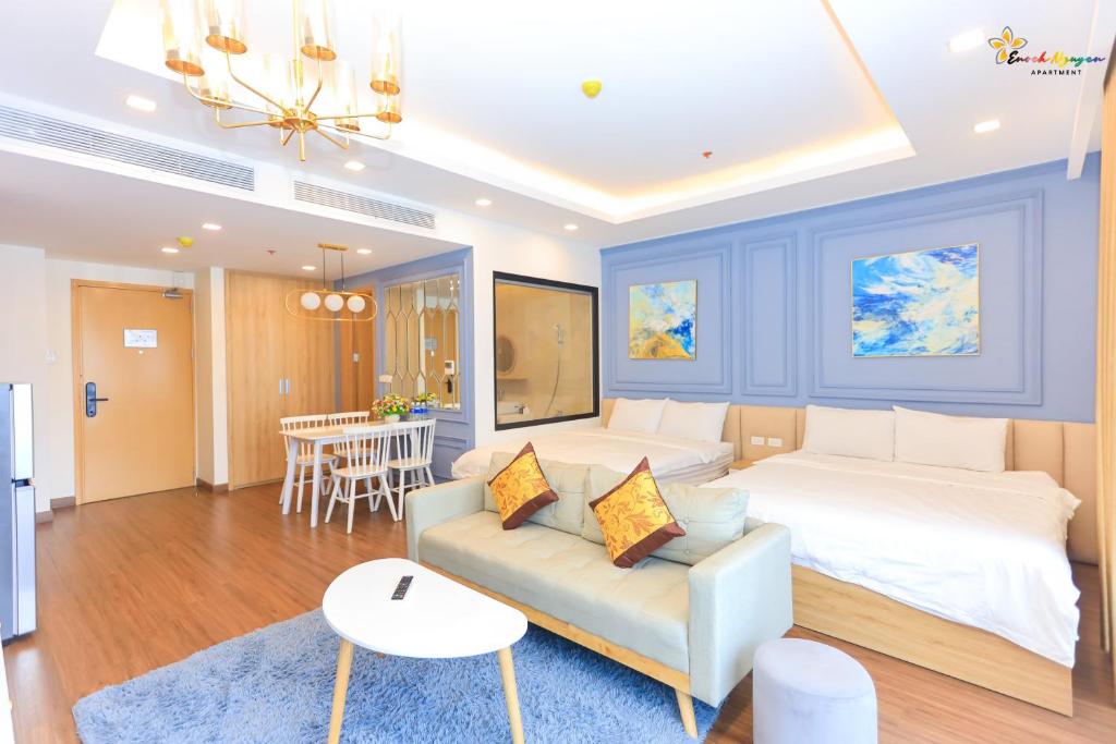 a bedroom with a bed and a couch and a table at FLC Sea Tower Căn Hộ View Biển Quy Nhơn in Quy Nhon