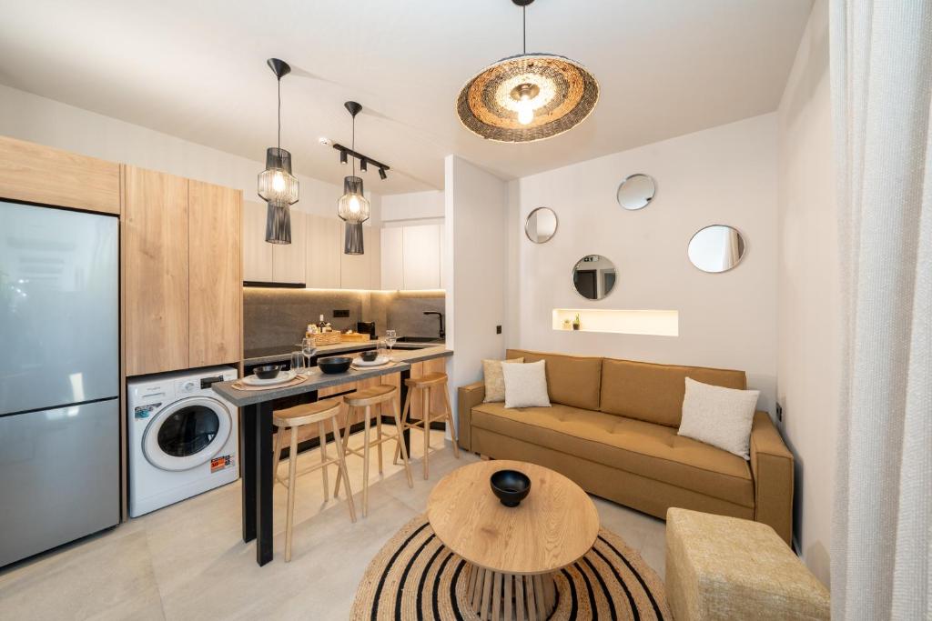 a living room and kitchen with a couch and a table at Paizan Homes - Kos City Center Apartments in Kos