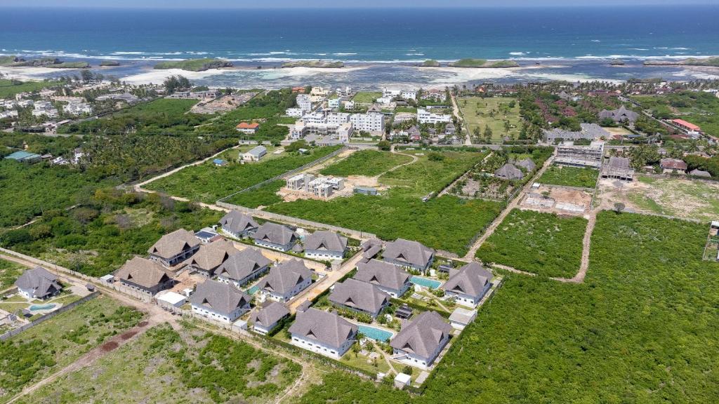 an aerial view of a neighborhood with houses and the ocean at Dunia & Bahari Resort in Watamu