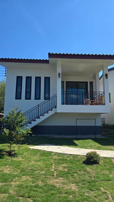 a large white house with a porch and balcony at Samati Hill - Sunset Pool Villa 6 - Klong Ning Beach in Ko Lanta Yai