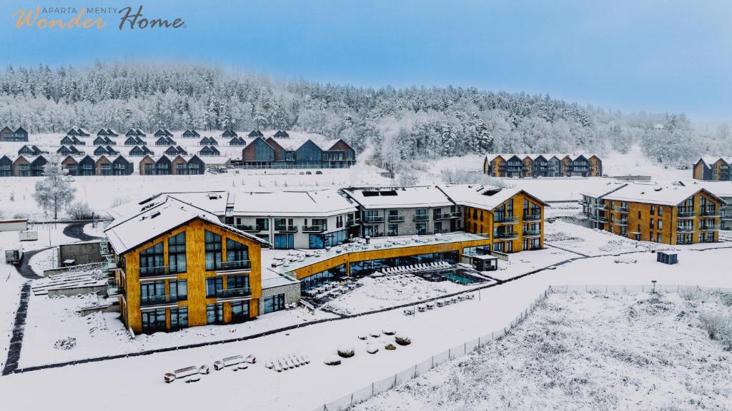 an aerial view of a resort in the snow at Wonder Hill - apartamenty hotelowe z dostępem do basenów i jacuzzi in Sosnówka