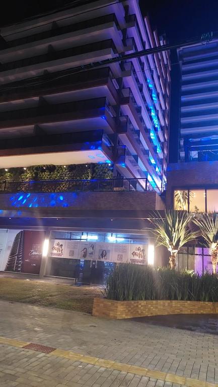a building with blue lights on the side of it at Studio Gardenia Mobiliado - Batista Campos in Belém
