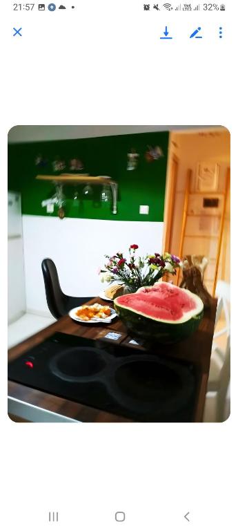a bowl of watermelon sitting on a stove top at Dreaming of Greece A4 in Athens