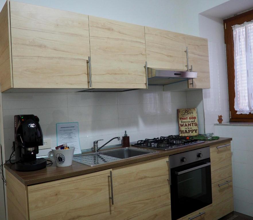 a kitchen with a sink and a stove at Casa Martina in Castellammare di Stabia