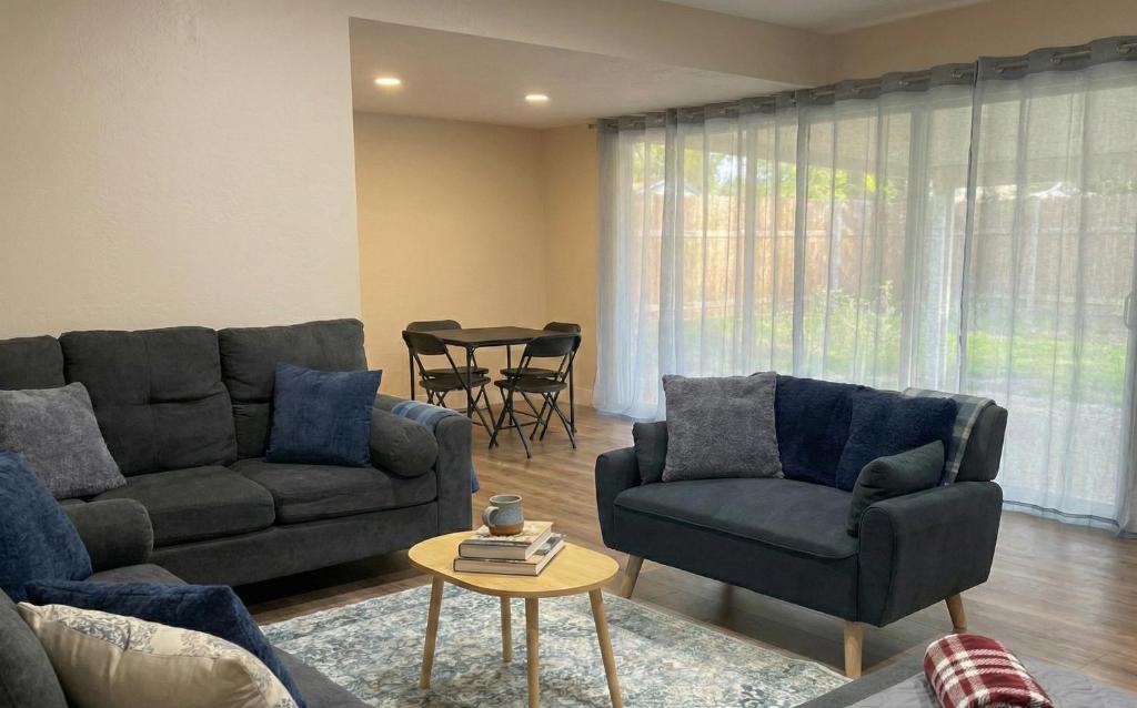a living room with two couches and a table at Pet & Family-Friendly 4BR Grill & Chill in Sacramento