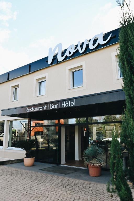 a hotel with a sign on the front of it at Hôtel Nova Adult Only- Villefranche sur Saône in Limas