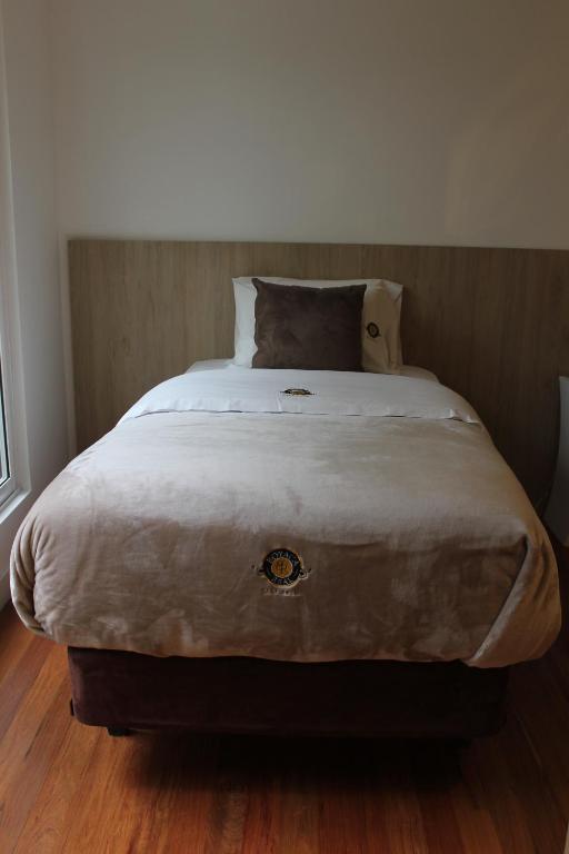 Postel nebo postele na pokoji v ubytování Casa Hotel Boyaca Real
