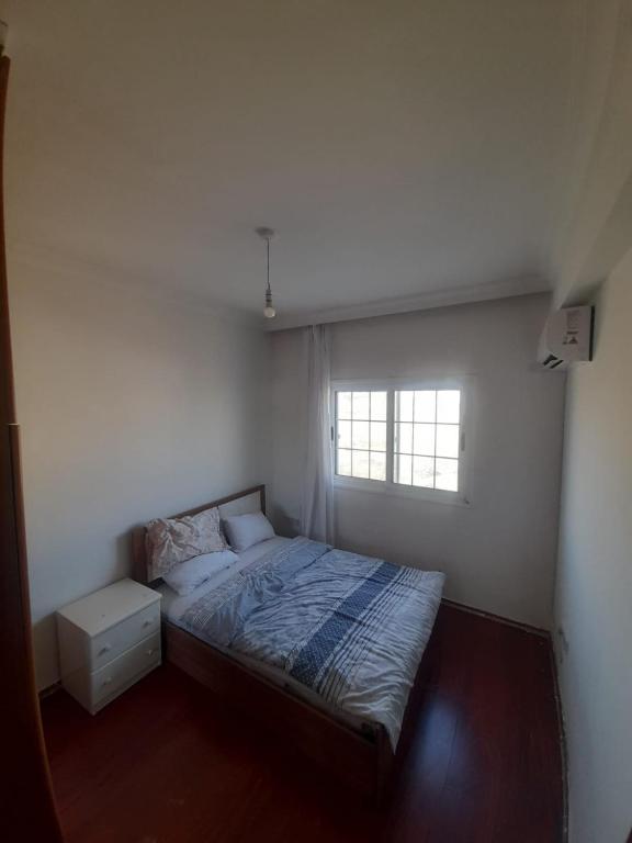 a small bedroom with a bed and a window at Daire in Kaimakli