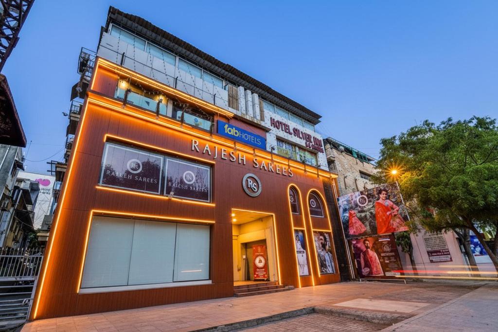 an orange building on the side of a street at FabHotel Silver Inn - CG road in Ahmedabad