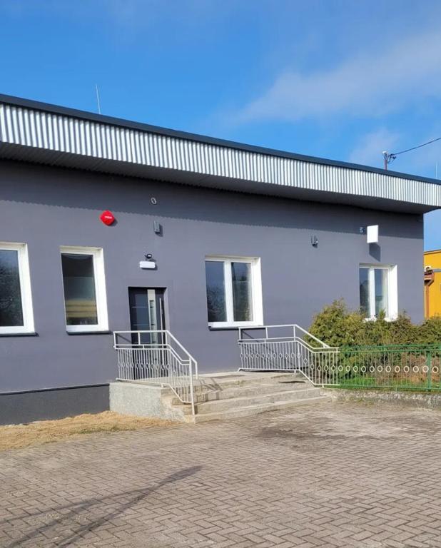 a white building with a red frisbee on it at Golenicka Przystań Golenice 73a in Golenice