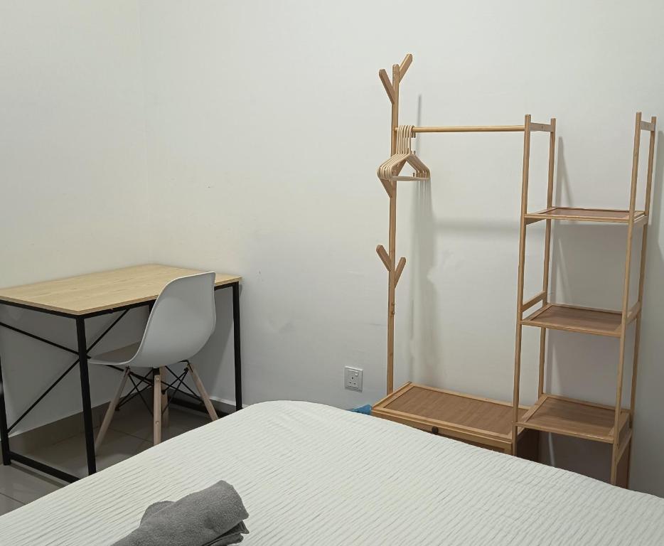 a bedroom with a bed and a desk and a chair at Amber Cove - Luxury Design By Luxpro Management - 6~7 pax in Melaka