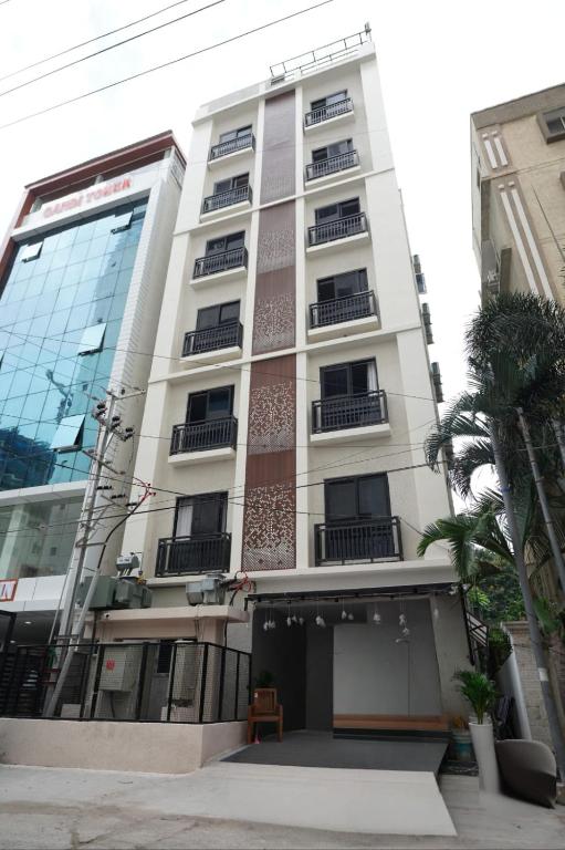 a tall white building with balconies on it at 23 Urban Suites, Hitech City in Hyderabad