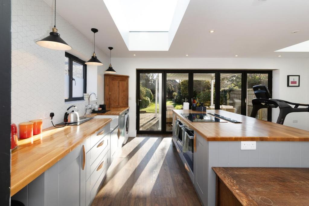 a large kitchen with wooden counter tops and a large window at Oxfordshire Country Escape, 3 Bed Getaway in Long Wittenham