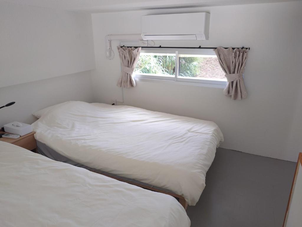 Ένα ή περισσότερα κρεβάτια σε δωμάτιο στο ペンションsakuraＬＥＦＴ