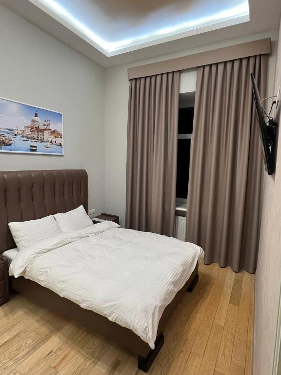 a bedroom with a large bed and a window at Отель Преображенский in Odesa