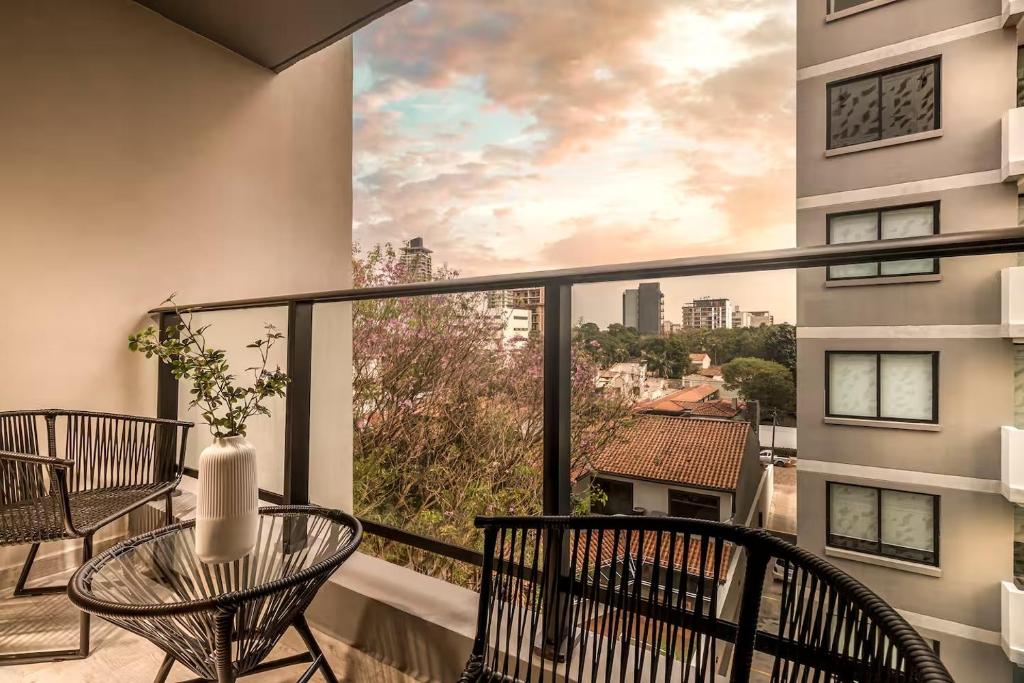 a balcony with a table and chairs and a view at Zuba IV in Luque