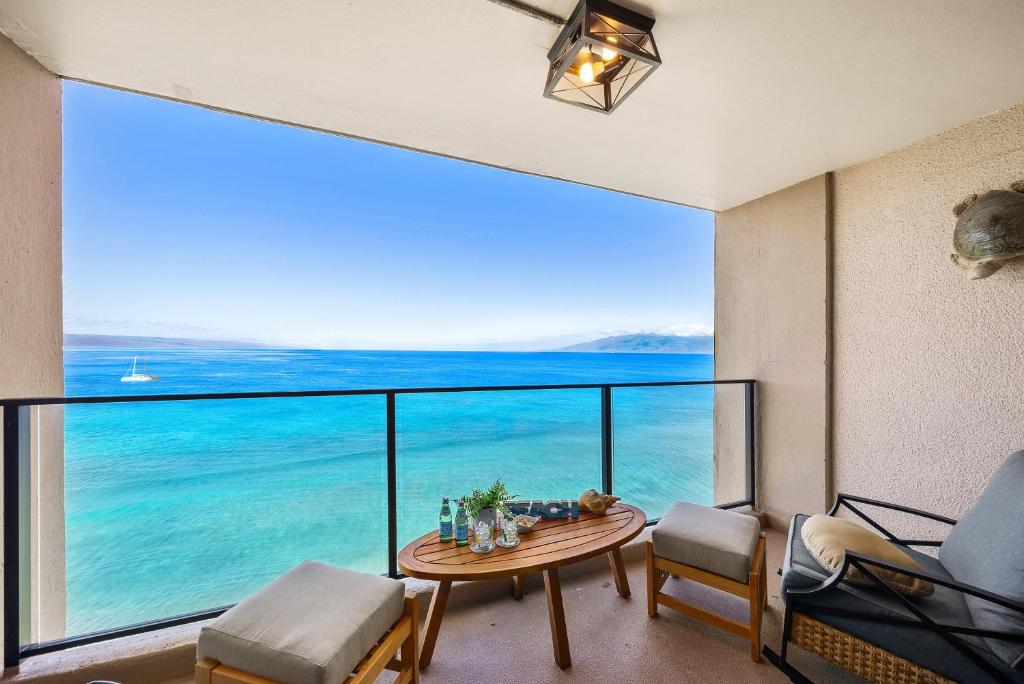 a room with a table and a view of the ocean at Mahana 1202 · MA 1202 OceanFront Penthouse Studio in Kaanapali in Kahana