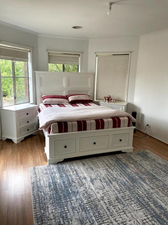 a bedroom with a large bed and a rug at Perfect peaceful stay in Melton