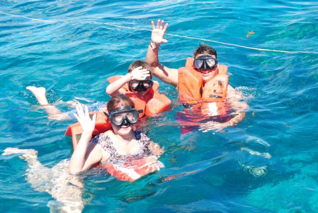 a group of people in the water at Sol & Arena Bayahibe Apartment in Bayahibe